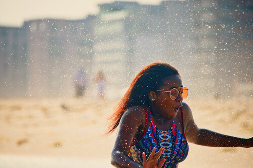 Woman splashed on beach