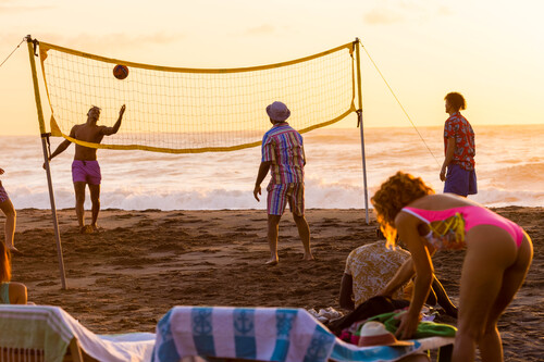 Playing volleyball a sunset