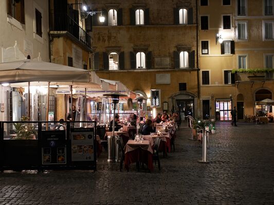 Outdoor restaurant terrace at night in Rome
